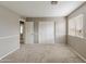 Well-lit bedroom includes double sliding door closet with plush carpet and a window at 2194 N Magdelena Pl, Casa Grande, AZ 85122