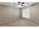 Neutral bedroom featuring carpeted floor, ceiling fan with light fixture, and window with blinds at 2194 N Magdelena Pl, Casa Grande, AZ 85122