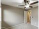 Bedroom with carpeted floor, ceiling fan, and an open door at 2194 N Magdelena Pl, Casa Grande, AZ 85122