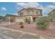 Two-story home with a two car garage, desert landscaping, and neutral color palette at 2194 N Magdelena Pl, Casa Grande, AZ 85122