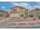 Two-story home with a two car garage, desert landscaping, and neutral color palette at 2194 N Magdelena Pl, Casa Grande, AZ 85122