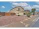 A two-story home's exterior featuring desert landscaping and a brick fence at 2194 N Magdelena Pl, Casa Grande, AZ 85122
