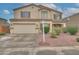 Two-story home with a two car garage, desert landscaping, and neutral color palette at 2194 N Magdelena Pl, Casa Grande, AZ 85122