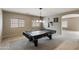 Bright game room with a pool table, natural light, and room for entertaining at 2194 N Magdelena Pl, Casa Grande, AZ 85122