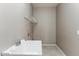 Bright laundry room featuring tiled floor, utility sink, and wire shelving at 2194 N Magdelena Pl, Casa Grande, AZ 85122