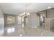Large living room with chandelier, tile floors and a view of the stairs at 2194 N Magdelena Pl, Casa Grande, AZ 85122