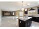 Open floor plan showcasing the kitchen with island and living area with custom built-ins at 2194 N Magdelena Pl, Casa Grande, AZ 85122