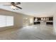 Living room with ceiling fan, plush carpet and sliding glass door at 2194 N Magdelena Pl, Casa Grande, AZ 85122