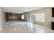 Open living area with tile and carpet flooring, with custom built-in shelving and a chandelier at 2194 N Magdelena Pl, Casa Grande, AZ 85122