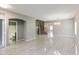 Spacious living room with stairs, chandelier, tile floor and open archways at 2194 N Magdelena Pl, Casa Grande, AZ 85122