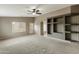 Spacious room with stylish ceiling fan, built-in shelves, and window offer natural light at 2194 N Magdelena Pl, Casa Grande, AZ 85122
