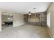 Spacious living room featuring a large built-in shelving unit and neutral carpeting at 2194 N Magdelena Pl, Casa Grande, AZ 85122