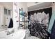 A compact bathroom featuring a floral shower curtain at 2916 N 48Th Ave, Phoenix, AZ 85031