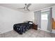 Simple bedroom with a ceiling fan, tiled floor, and natural light at 2916 N 48Th Ave, Phoenix, AZ 85031