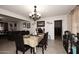 Inviting dining room with chandelier, adjacent living room, and tile floors at 2916 N 48Th Ave, Phoenix, AZ 85031
