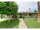 Charming single-story home with a well-manicured lawn and a quaint, inviting front porch at 2916 N 48Th Ave, Phoenix, AZ 85031