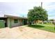 Charming single-story home with well-kept lawn, a wide driveway, and lush green trees at 2916 N 48Th Ave, Phoenix, AZ 85031