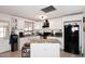 Bright kitchen featuring an island, white cabinets, and black appliances at 2916 N 48Th Ave, Phoenix, AZ 85031
