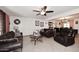 Comfortable living room featuring ceiling fan, tile floors, and plush sofas for relaxation at 2916 N 48Th Ave, Phoenix, AZ 85031