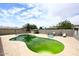 An algae covered outdoor pool surrounded by a patio and landscaping at 2916 N 48Th Ave, Phoenix, AZ 85031