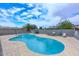 Backyard pool featuring clear blue water, concrete surround, block fence and a table and chairs set at 2916 N 48Th Ave, Phoenix, AZ 85031