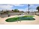 An algae covered outdoor pool surrounded by a patio and landscaping at 2916 N 48Th Ave, Phoenix, AZ 85031
