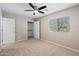This bedroom has neutral walls, carpet, a ceiling fan, and a window letting in natural light at 3010 N 37Th St # 6, Phoenix, AZ 85018