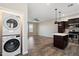 Open-concept living space with modern wood flooring, stainless steel appliances, and pendant lighting above the kitchen island at 3010 N 37Th St # 6, Phoenix, AZ 85018