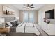 Comfortable main bedroom featuring a bed, dresser, fan, and doors to the outside at 3010 N 37Th St # 6, Phoenix, AZ 85018