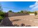 Landscaped backyard featuring gravel, trees, and a block fence at 3034 E Turney Ave, Phoenix, AZ 85016