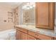 Bathroom featuring granite counters, tile backsplash and shower with built-in shelving at 3034 E Turney Ave, Phoenix, AZ 85016