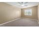 Neutral bedroom featuring a ceiling fan, carpet, and a window with blinds at 3034 E Turney Ave, Phoenix, AZ 85016