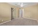 Carpeted bedroom featuring a ceiling fan and mirrored closet at 3034 E Turney Ave, Phoenix, AZ 85016