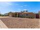 A well-maintained single-story home with a low-water landscape, covered entry, and side yard access at 3034 E Turney Ave, Phoenix, AZ 85016