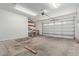 Spacious garage featuring storage shelves and a rolling garage door at 3034 E Turney Ave, Phoenix, AZ 85016