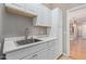 Spacious laundry room features a utility sink, white cabinets, and easy access to the kitchen at 3034 E Turney Ave, Phoenix, AZ 85016
