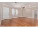 Spacious living room features beautiful wood floors, a ceiling fan, and abundant natural light from a large window at 3034 E Turney Ave, Phoenix, AZ 85016