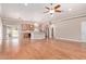 Open-concept living area with hardwood flooring, ceiling fan, and seamless flow to the kitchen and outdoor spaces at 3034 E Turney Ave, Phoenix, AZ 85016