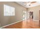 Bright living room with hardwood floors, fan, and sliding glass door at 3034 E Turney Ave, Phoenix, AZ 85016