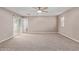 Sunlit primary bedroom showcases a ceiling fan, plush carpeting, and convenient patio access at 3034 E Turney Ave, Phoenix, AZ 85016