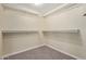 Well-organized walk-in closet with carpet and shelving units for optimal storage solutions at 3034 E Turney Ave, Phoenix, AZ 85016