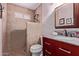 Modern bathroom with a tiled shower, stylish vanity, and granite countertop at 317 E Harwell Rd, Gilbert, AZ 85234