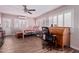 Inviting bedroom with desk, ceiling fan, shuttered windows, and wood-look tile flooring at 317 E Harwell Rd, Gilbert, AZ 85234