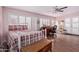 Sunlit bedroom featuring wood-look floors, shutters, and a decorative glass cabinet at 317 E Harwell Rd, Gilbert, AZ 85234