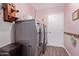Functional laundry room with side-by-side washer and dryer for added convenience at 317 E Harwell Rd, Gilbert, AZ 85234
