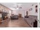 Comfortable living room with stone fireplace, wood flooring, and neutral color palette at 317 E Harwell Rd, Gilbert, AZ 85234