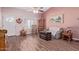 Cozy living room featuring wood-look tile flooring, and a ceiling fan at 317 E Harwell Rd, Gilbert, AZ 85234