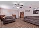 Spacious living room featuring wood-look tile flooring and neutral walls at 317 E Harwell Rd, Gilbert, AZ 85234