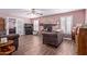 Inviting living room featuring a stone fireplace, ceiling fan, and wood-look tile flooring at 317 E Harwell Rd, Gilbert, AZ 85234