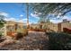 Backyard with planter boxes, rock ground cover, and canvas providing shade for the garden area at 322 N Williams St, Mesa, AZ 85203